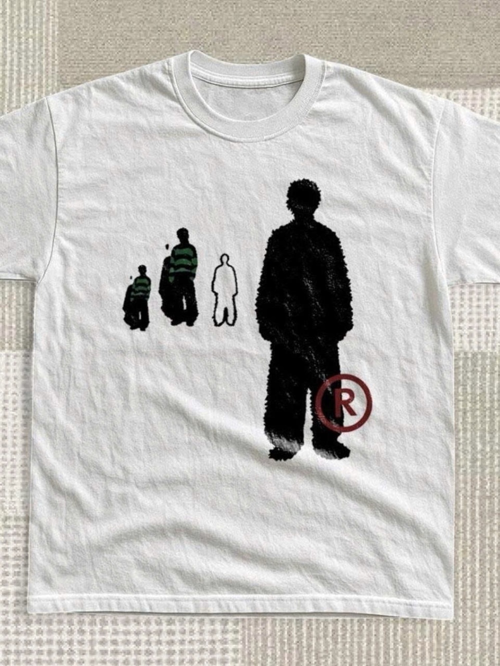 White Tee with Black Silhouette and Green Stripe Figures